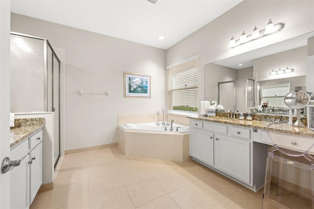 full bath with baseboards, tile patterned flooring, vanity, a shower stall, and a bath