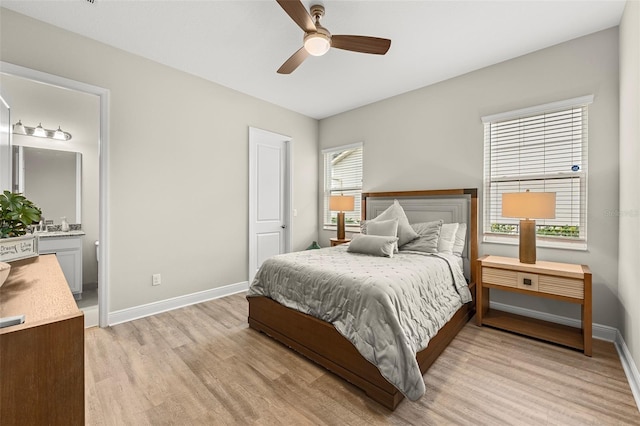 bedroom featuring ceiling fan, connected bathroom, light wood-style flooring, and baseboards