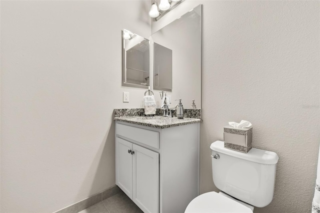 half bath featuring toilet, tile patterned floors, baseboards, and vanity