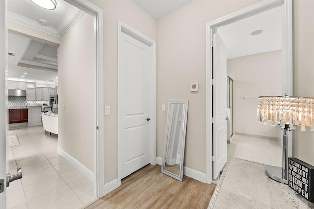 hallway with light tile patterned floors, recessed lighting, visible vents, and baseboards