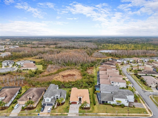 birds eye view of property featuring a forest view and a residential view