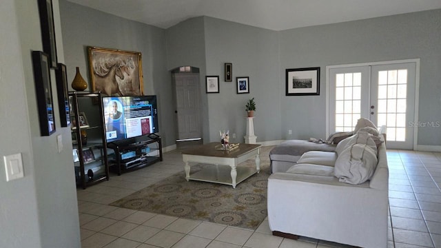 living room featuring light tile patterned floors and french doors