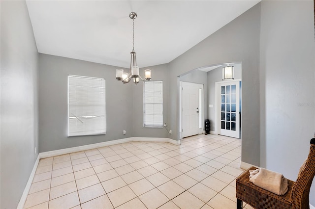 915 Poinsettia Ave, Lehigh Acres, FL 33972 - interior space featuring light tile patterned floors, baseboards, arched walkways, an inviting chandelier, and lofted ceiling