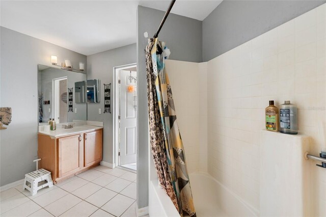 915 Poinsettia Ave, Lehigh Acres, FL 33972 - bathroom featuring vanity, baseboards, tile patterned flooring, and shower / tub combo with curtain