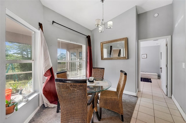 915 Poinsettia Ave, Lehigh Acres, FL 33972 - dining space with light tile patterned floors, baseboards, vaulted ceiling, and an inviting chandelier