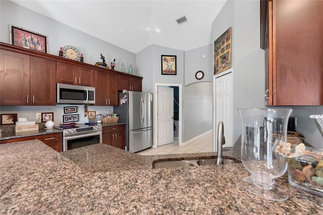 915 Poinsettia Ave, Lehigh Acres, FL 33972 - kitchen featuring dark stone countertops, a sink, visible vents, and stainless steel appliances