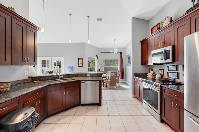 915 Poinsettia Ave, Lehigh Acres, FL 33972 - kitchen with a sink, plenty of natural light, a chandelier, and stainless steel appliances