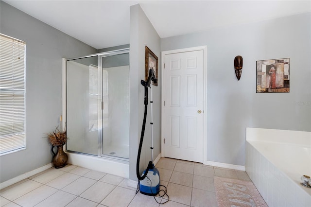 915 Poinsettia Ave, Lehigh Acres, FL 33972 - bathroom featuring a shower stall, tile patterned floors, baseboards, and a garden tub