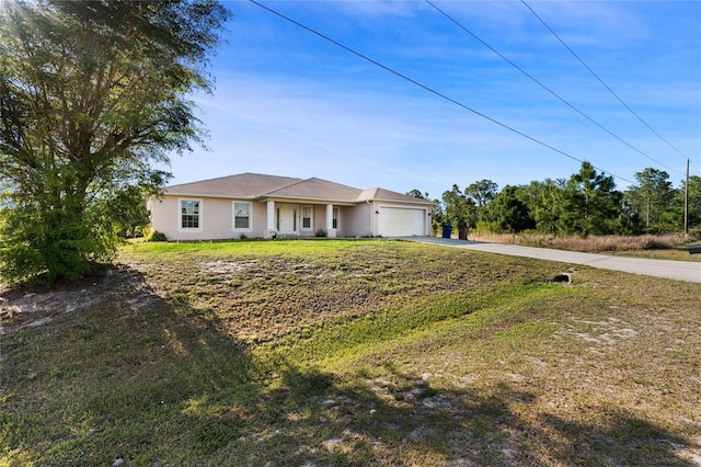 915 Poinsettia Ave, Lehigh Acres, FL 33972 - single story home featuring concrete driveway, a front yard, stucco siding, and a garage