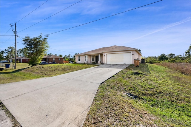 915 Poinsettia Ave, Lehigh Acres, FL 33972 - single story home with a front yard, driveway, stucco siding, and an attached garage