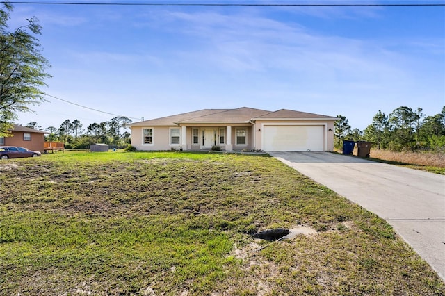 915 Poinsettia Ave, Lehigh Acres, FL 33972 - view of front facade featuring a garage, a front yard, driveway, and stucco siding