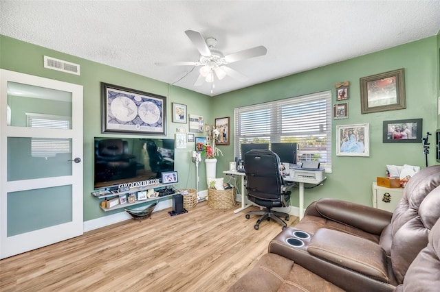 office featuring ceiling fan, wood-type flooring, and a textured ceiling