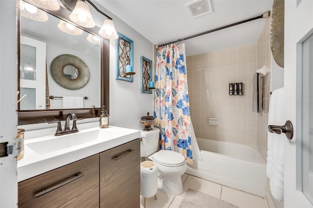 full bathroom featuring toilet, tile patterned floors, vanity, and shower / bath combo with shower curtain