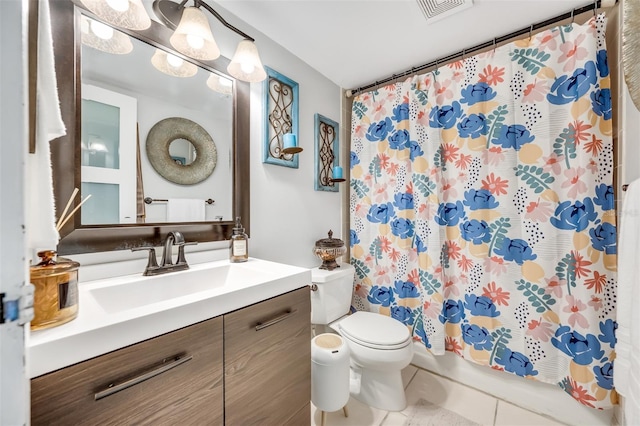 bathroom with toilet, tile patterned floors, and vanity