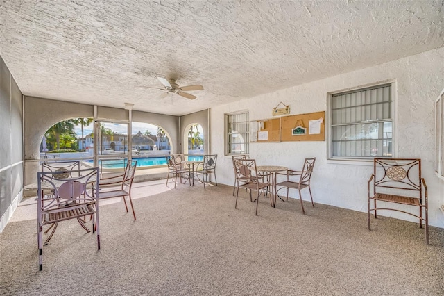 sunroom featuring ceiling fan