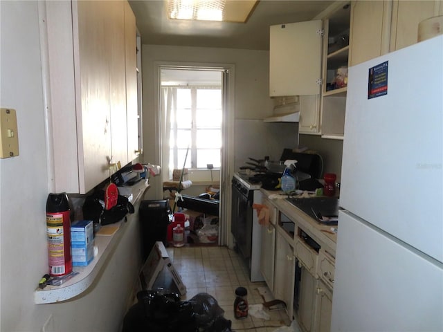 kitchen featuring cream cabinets and white appliances