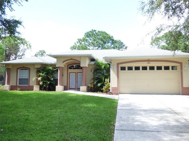 view of front of home with a garage and a front lawn