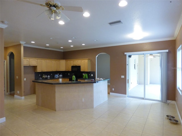 kitchen with crown molding, light tile patterned floors, and a kitchen island with sink