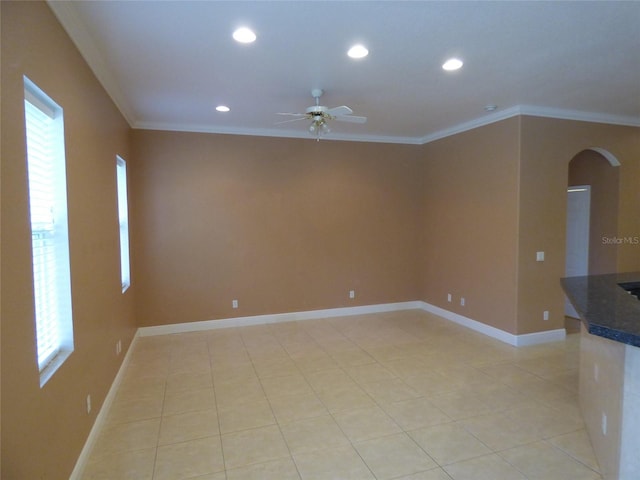 unfurnished room featuring ceiling fan and ornamental molding