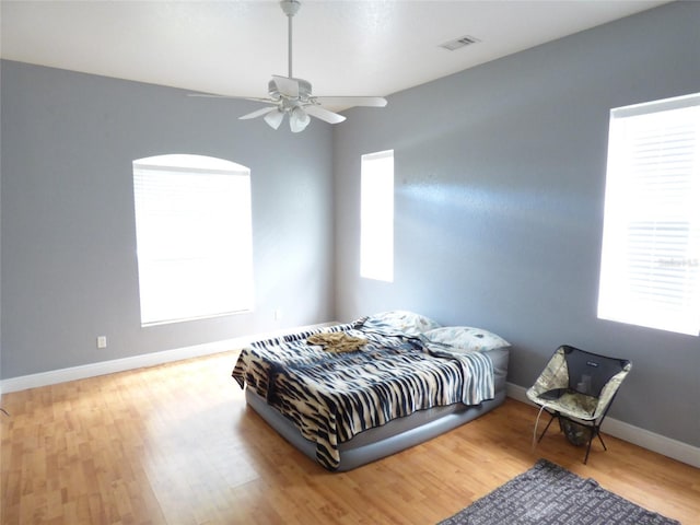 bedroom with ceiling fan and wood-type flooring