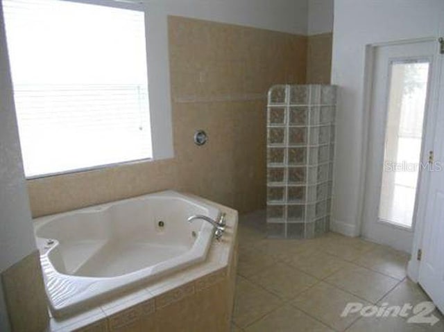 bathroom featuring independent shower and bath and tile patterned floors