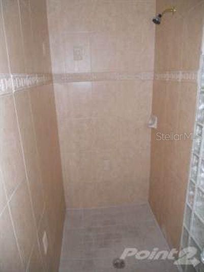 bathroom with a tile shower