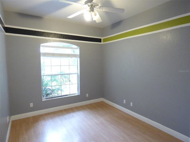 empty room with ceiling fan and hardwood / wood-style floors