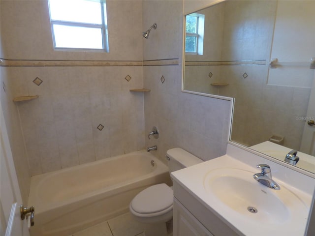 full bathroom featuring toilet, tiled shower / bath combo, tile patterned floors, and vanity