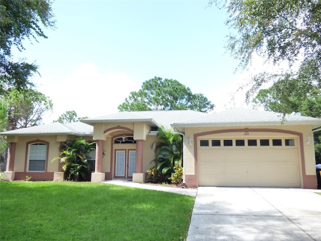 view of front facade with a front yard and a garage