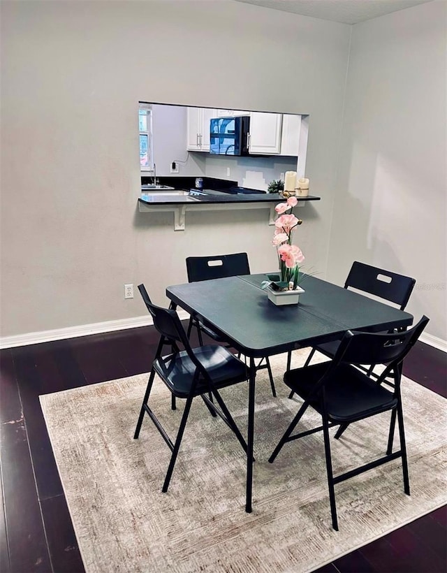 dining room with sink and hardwood / wood-style floors