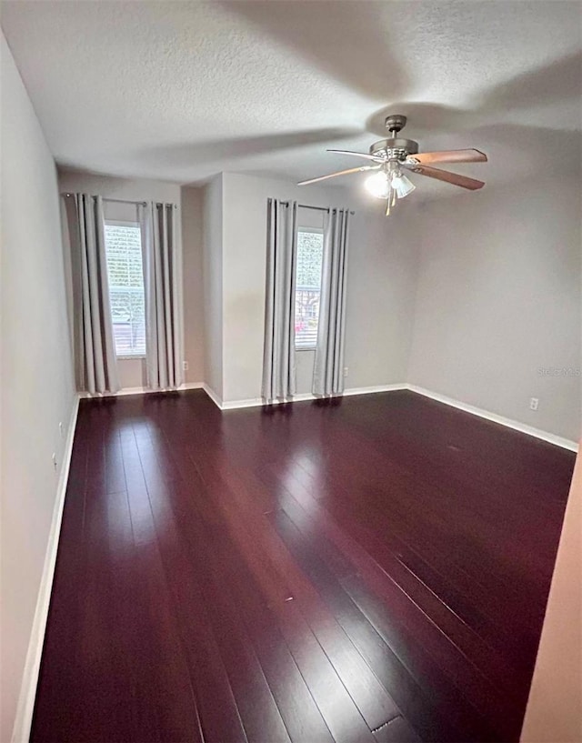 unfurnished room featuring hardwood / wood-style flooring, ceiling fan, and a wealth of natural light