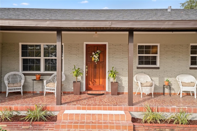 view of exterior entry with a porch