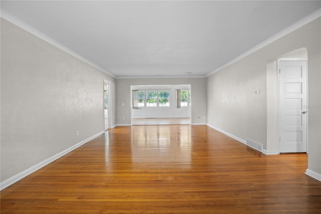 unfurnished room featuring crown molding and hardwood / wood-style flooring