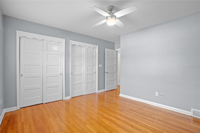 unfurnished bedroom featuring ceiling fan, a closet, and light wood-type flooring