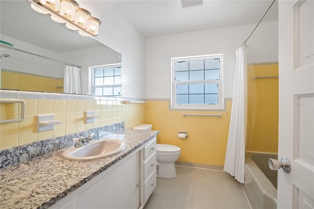 full bathroom with tile patterned flooring, tile walls, vanity, shower / bath combination with curtain, and toilet