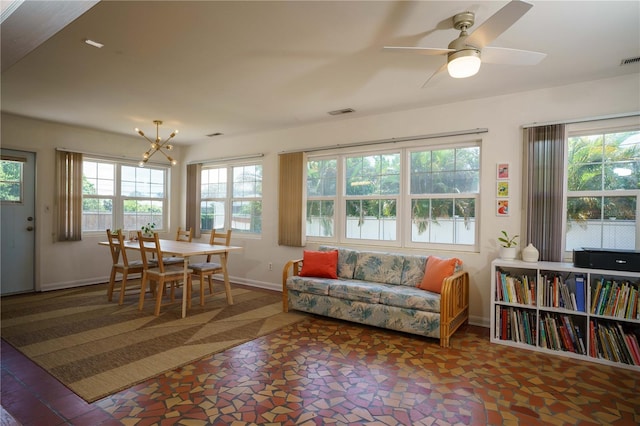 interior space with ceiling fan with notable chandelier and a wealth of natural light