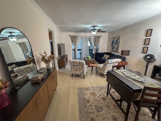 living room with crown molding, a textured ceiling, and light hardwood / wood-style floors