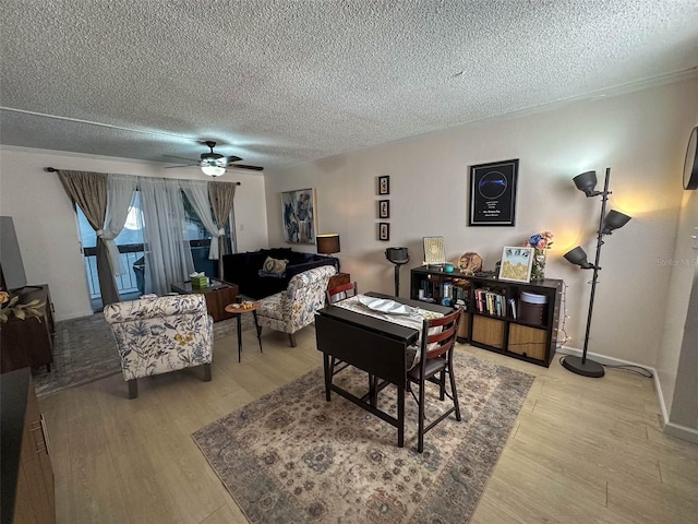 living room featuring a textured ceiling, ceiling fan, and hardwood / wood-style floors