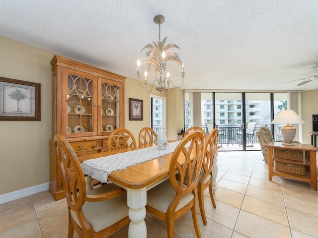 dining space featuring floor to ceiling windows, ceiling fan with notable chandelier, light tile patterned floors, and a textured ceiling