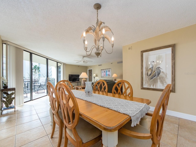 dining space with light tile patterned floors, ceiling fan with notable chandelier, floor to ceiling windows, and a textured ceiling