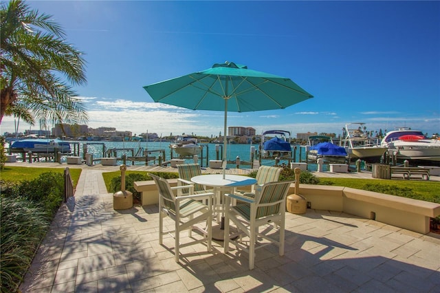 view of patio / terrace with a boat dock and a water view