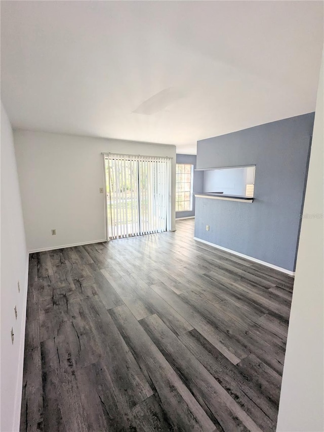 unfurnished living room featuring dark hardwood / wood-style floors