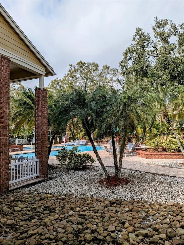 view of yard featuring a patio and a community pool