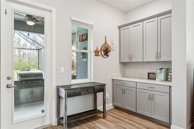 interior space with gray cabinets and ceiling fan