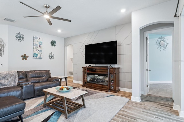 living room with light hardwood / wood-style flooring and ceiling fan