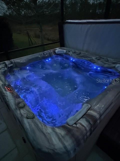 view of swimming pool featuring a hot tub