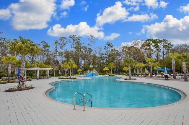 view of swimming pool with a pergola and a patio