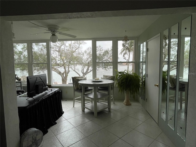 sunroom featuring ceiling fan