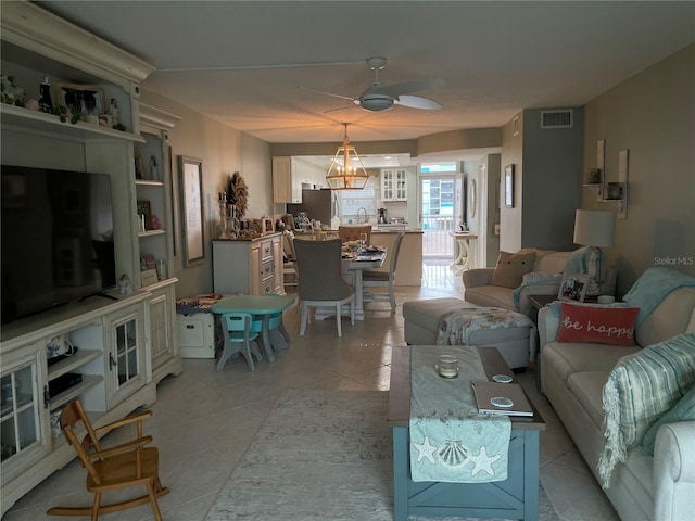 tiled living room with ceiling fan