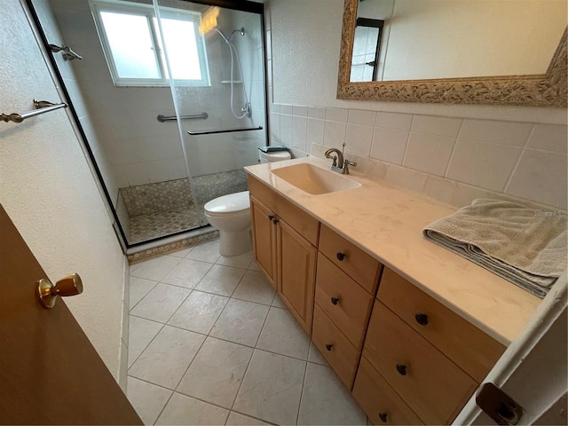 bathroom featuring walk in shower, tile patterned floors, toilet, tile walls, and vanity